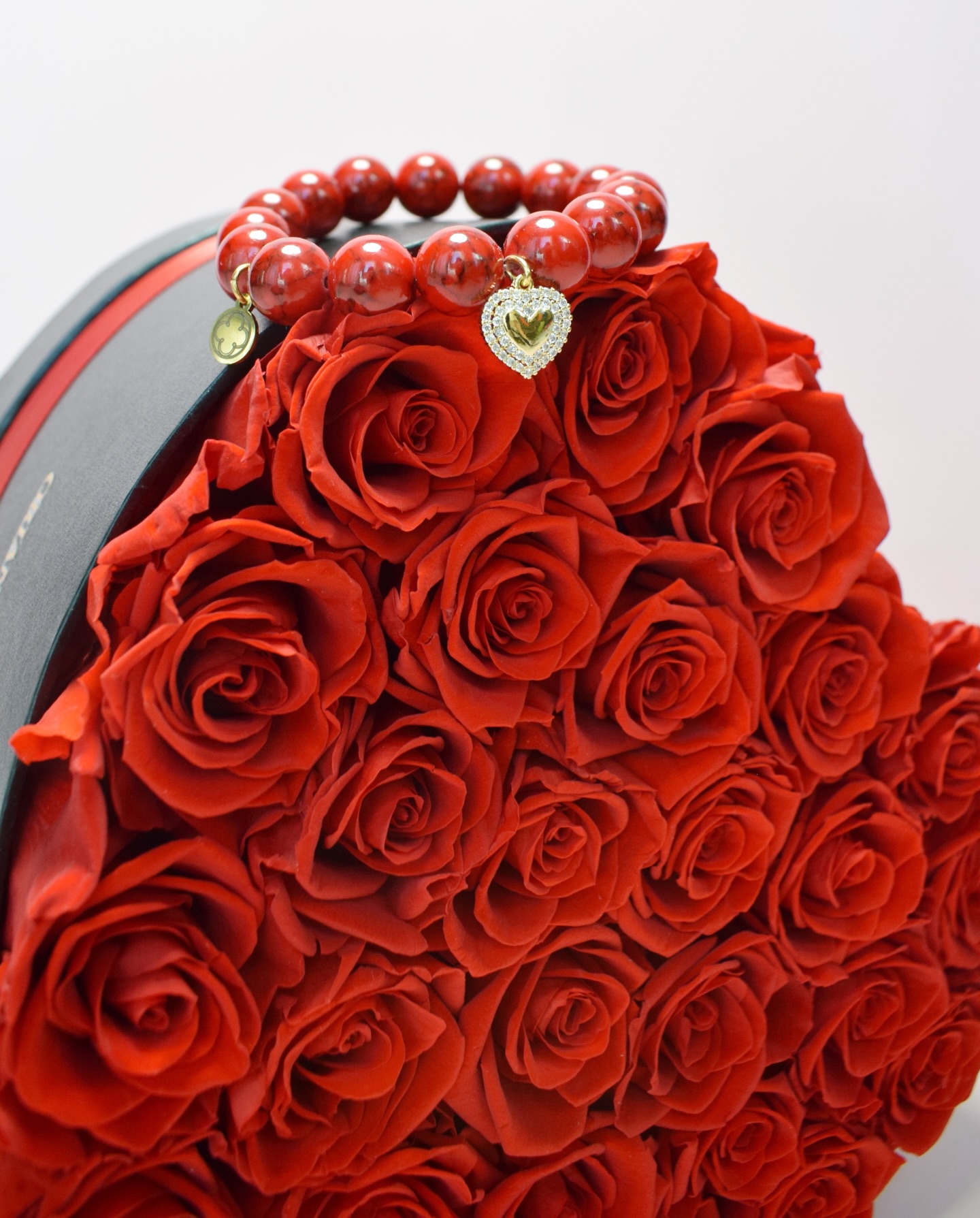 Red roses with coral bracelet