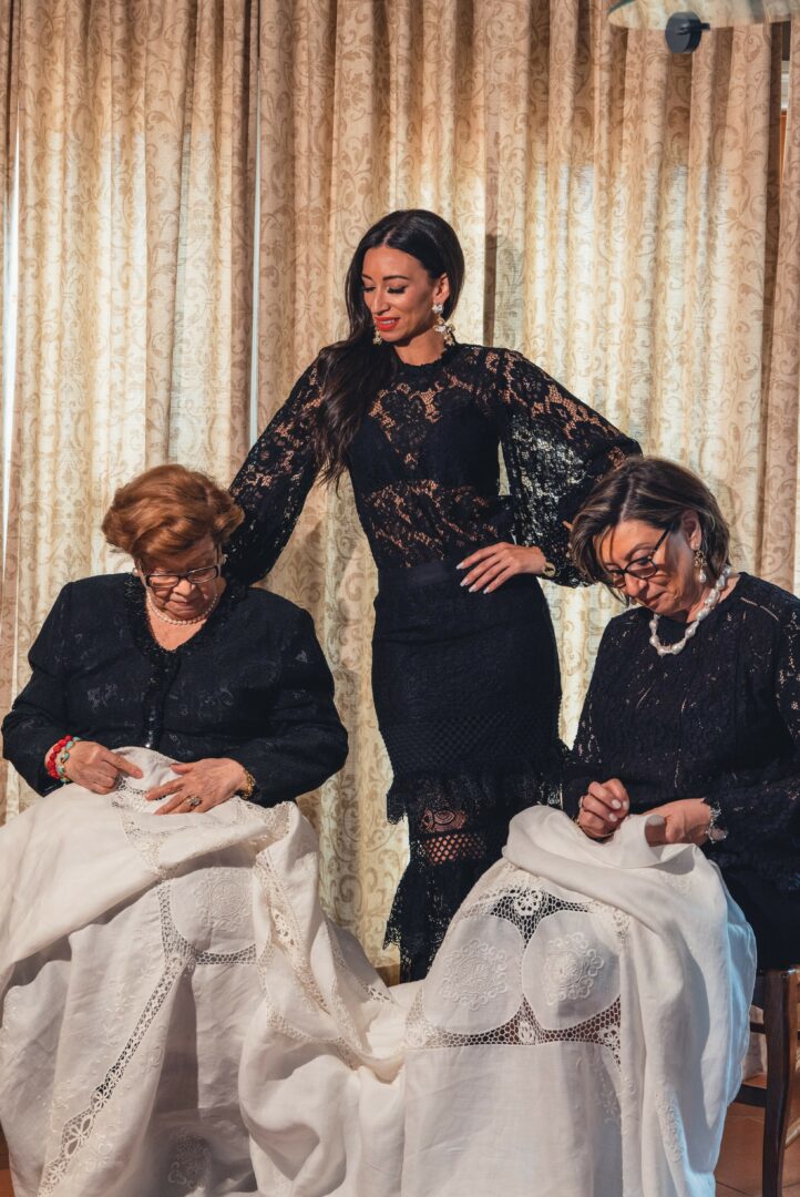 Oriana with her grandmothers — lace and tradition
